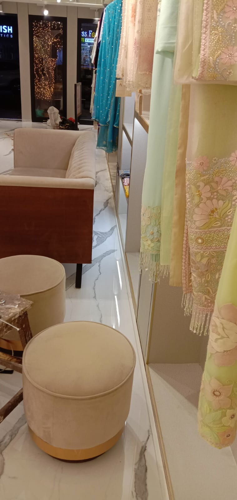 Boutique Customer Lounge with Round Velvet Poufs
